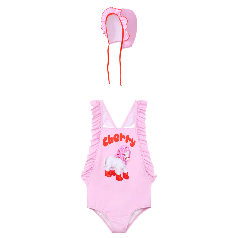 Cherry Pony Ruffle Swimsuit with matching swim cap flat lay by Poco Blush