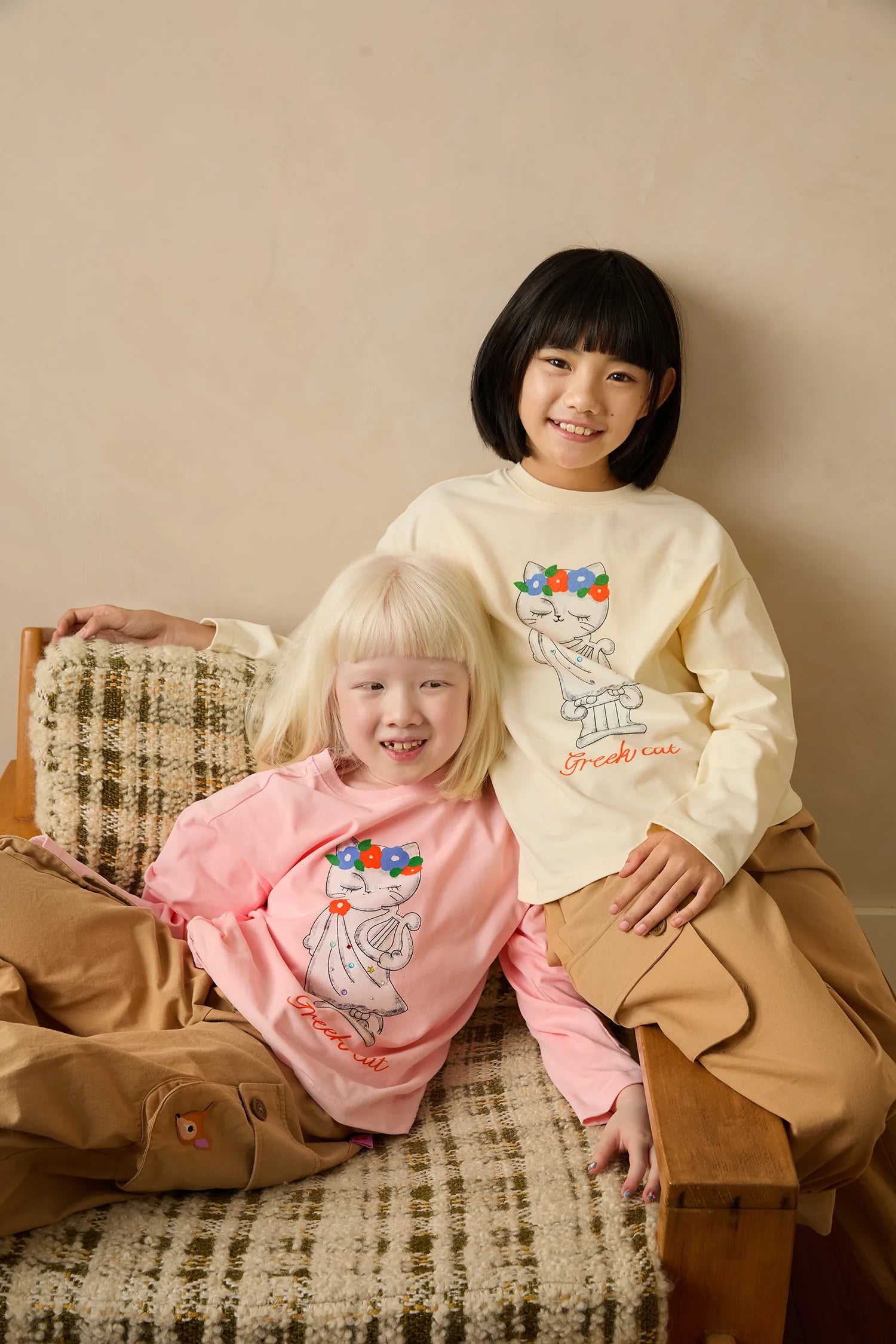 Two children wearing Greek Cat crystal tees