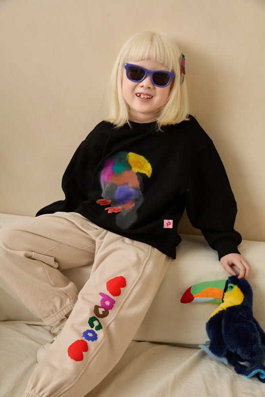 Model wearing a black Ink-Wash Animals sweatshirt and purple sunglasses.