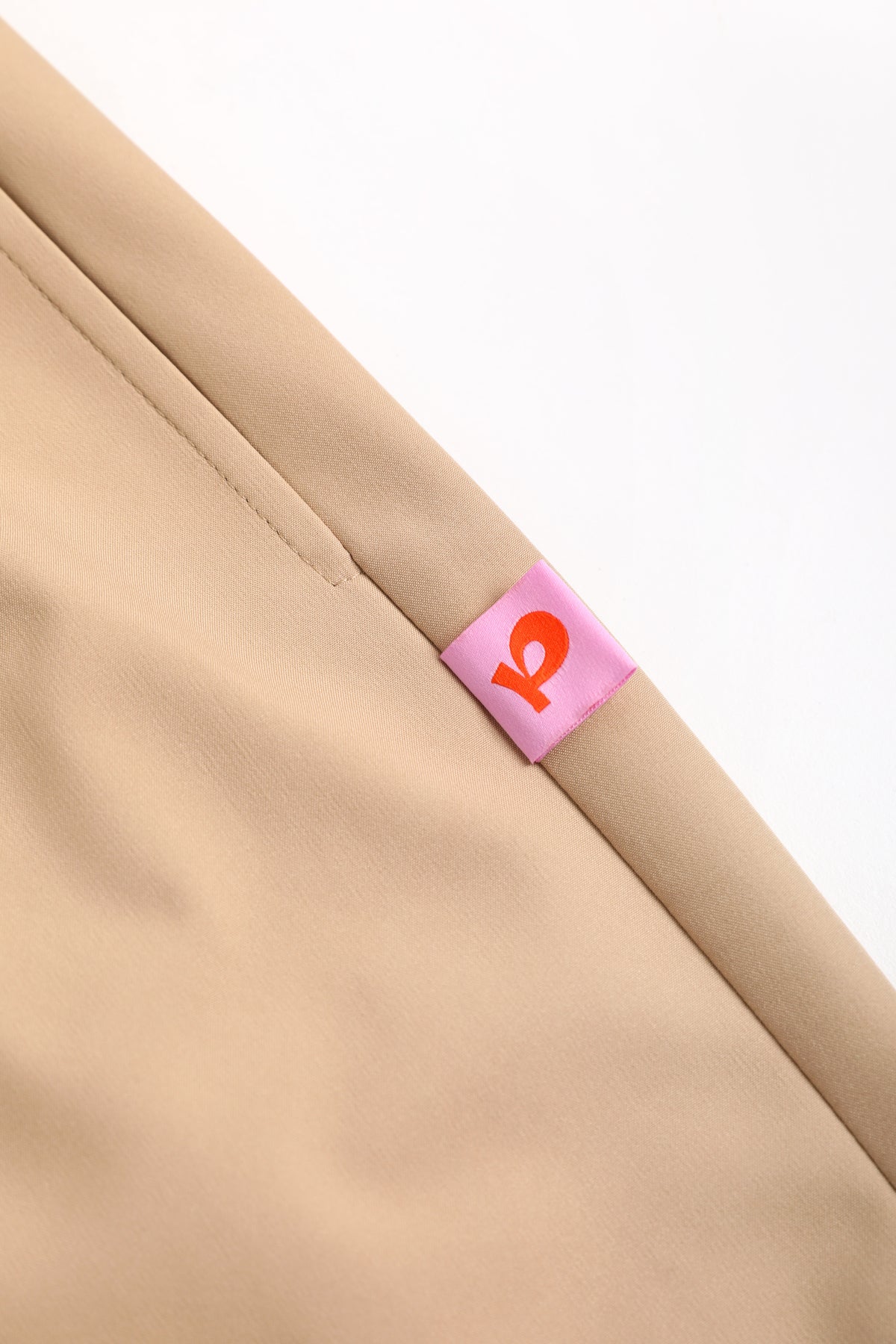 Ink-Wash Fleece-Backed Trousers — Soft Ochre; construction and decoration detail