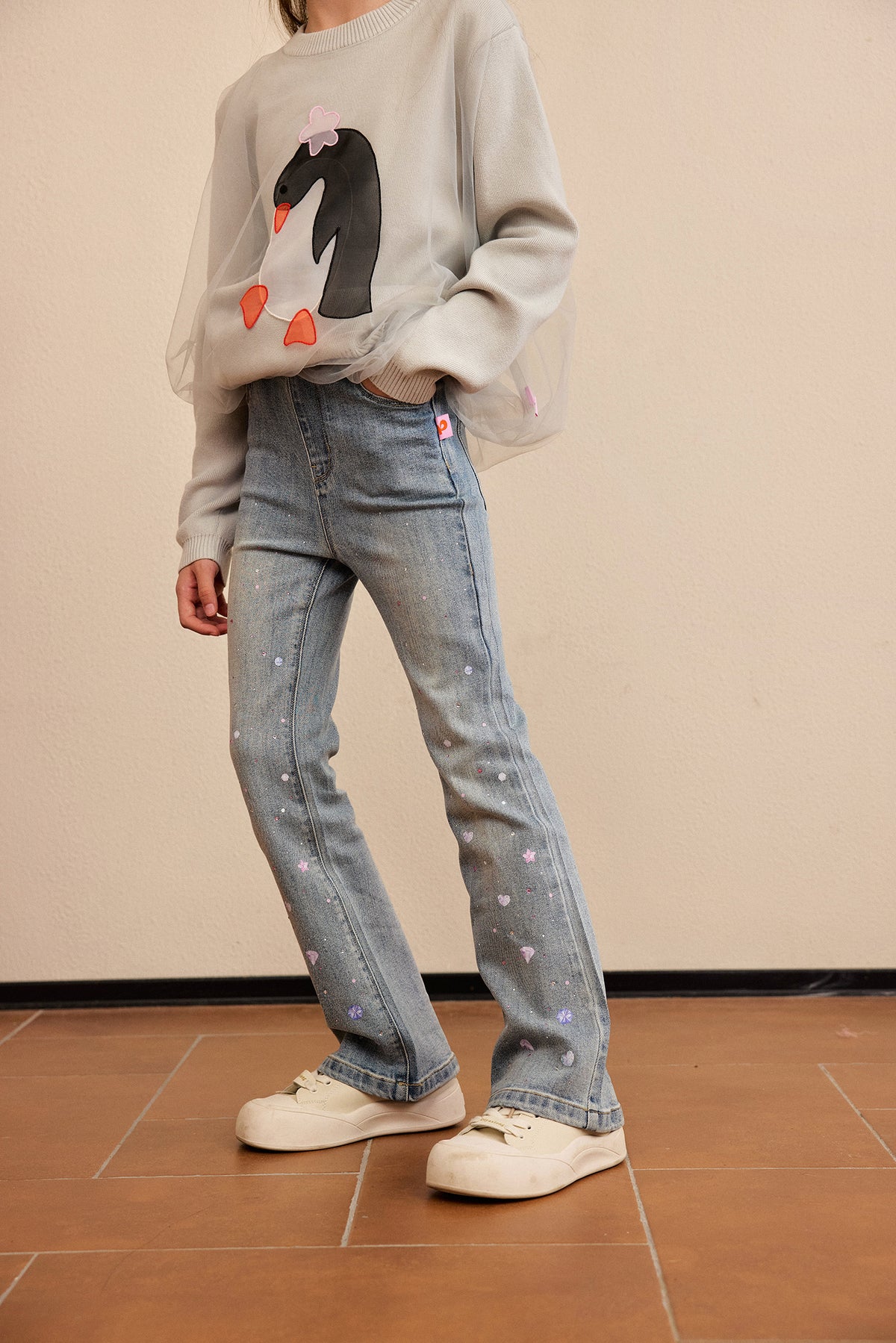 Crystal-Print Flared Jeans — Denim Blue; worn view; other styled garments and accessories are not included