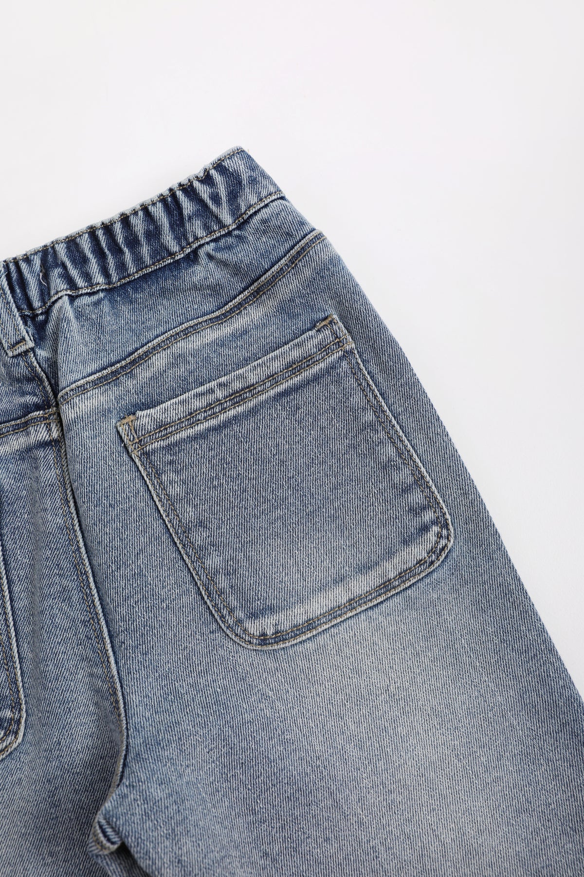 Crystal-Print Flared Jeans — Denim Blue; construction and decoration detail
