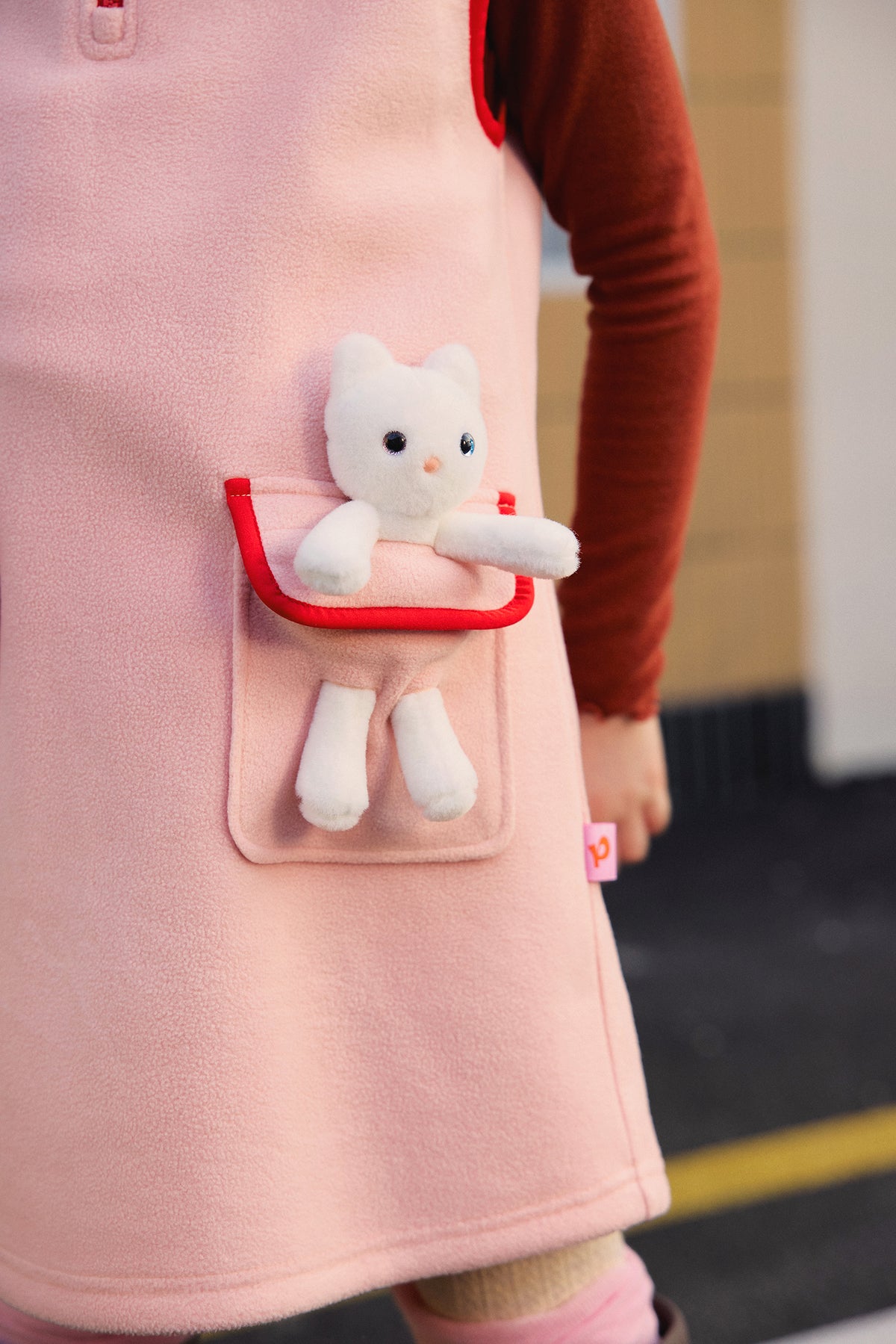 Ink-Wash Animal-Pocket Fleece Pinafore — Dusty Pink; worn view; other styled garments and accessories are not included