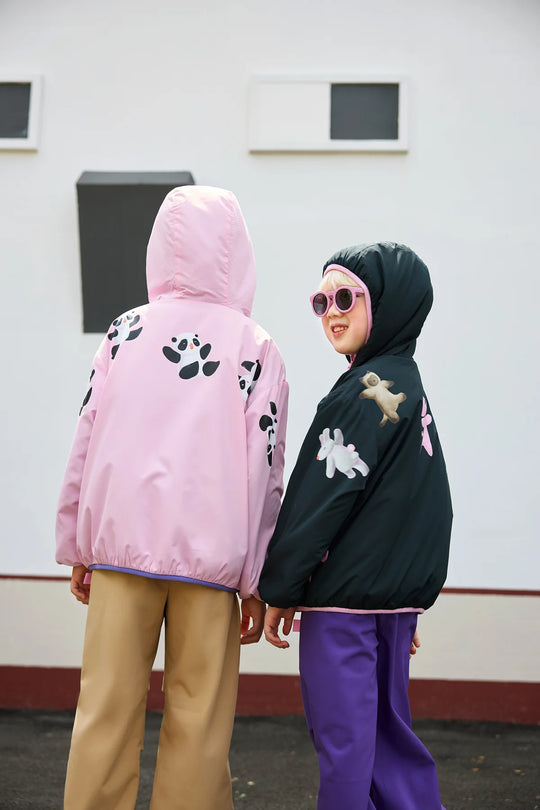 The printed backs of the Reversible Hooded Fleece Jacket in peach pink and black.