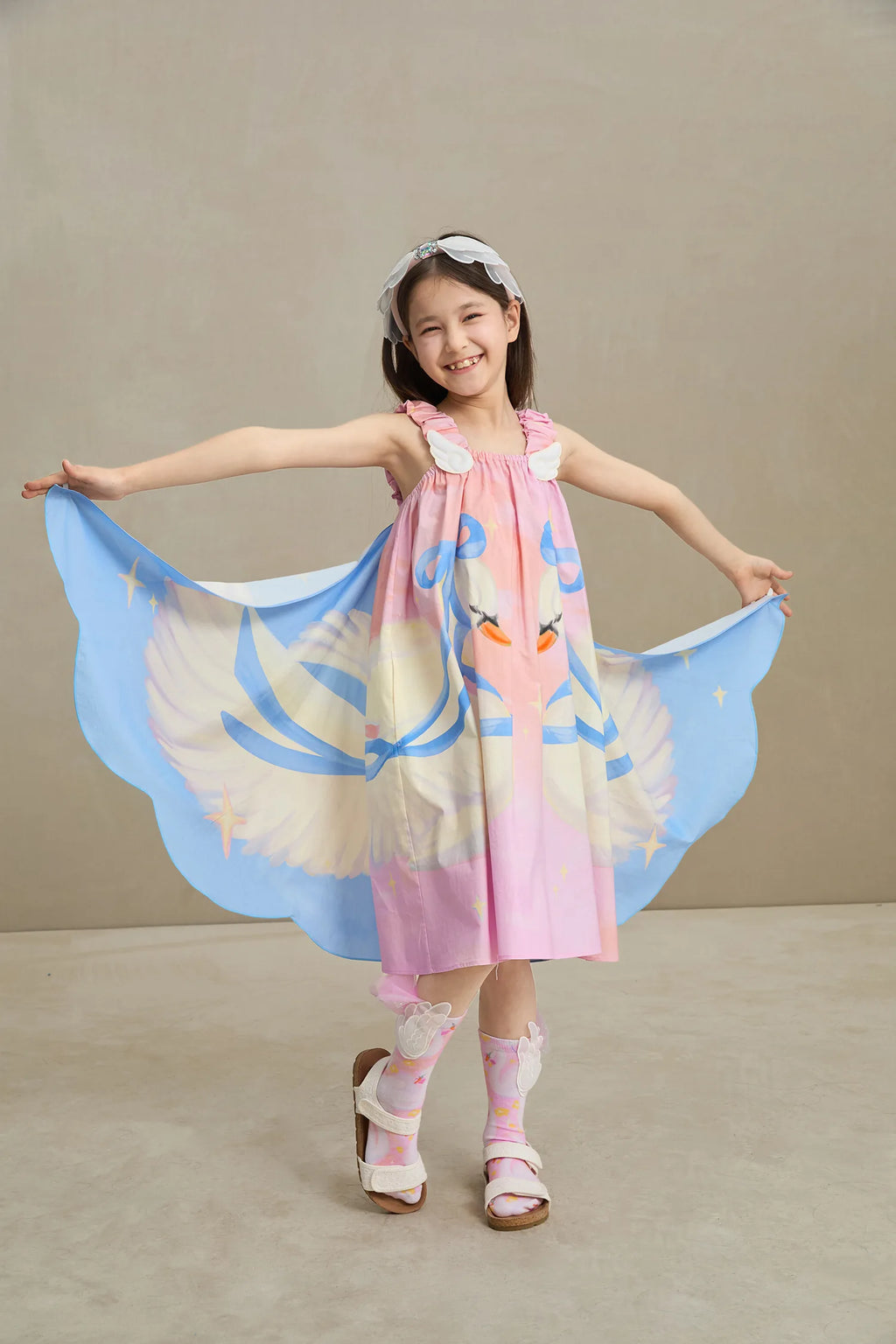 Poco Blush Swan Wing Art Print Dress — playful kids clothing for girls